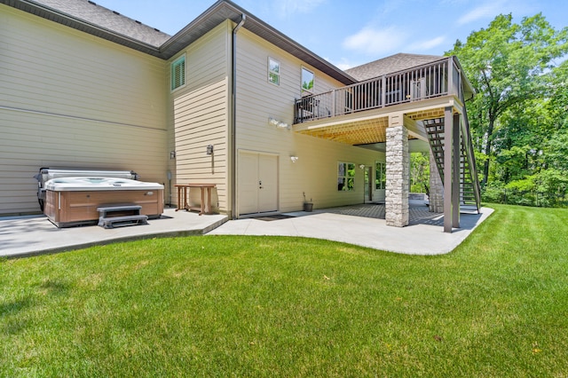 1880 W Cresskill Dr, Columbia, MO 65203 - back of property with a hot tub, a patio, a wooden deck, and a lawn