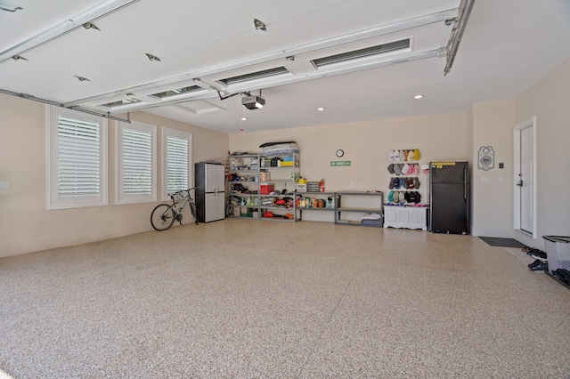 1880 W Cresskill Dr, Columbia, MO 65203 - garage with freestanding refrigerator, a garage door opener, and recessed lighting