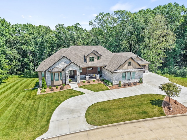 1880 W Cresskill Dr, Columbia, MO 65203 - view of front of property with stone siding, concrete driveway, a front yard, and roof with shingles