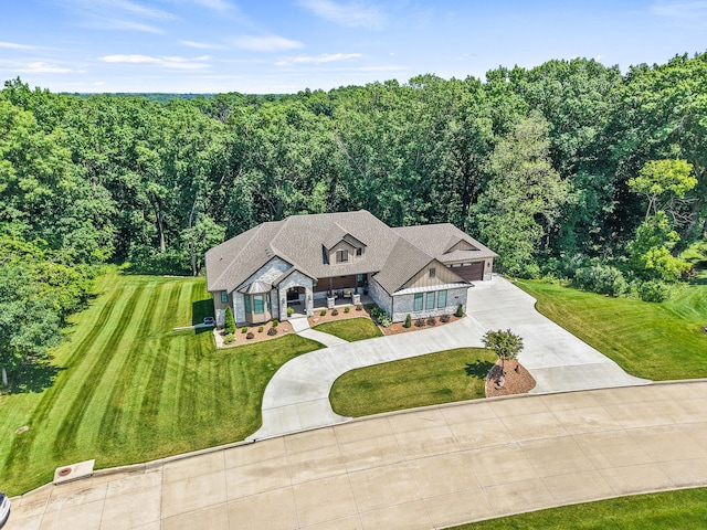 1880 W Cresskill Dr, Columbia, MO 65203 - view of front facade featuring driveway, a front yard, stone siding, board and batten siding, and an attached garage