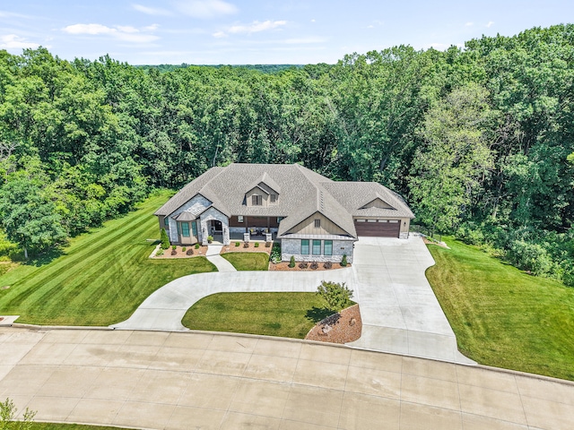 1880 W Cresskill Dr, Columbia, MO 65203 - view of front of property featuring concrete driveway, stone siding, a front yard, and an attached garage