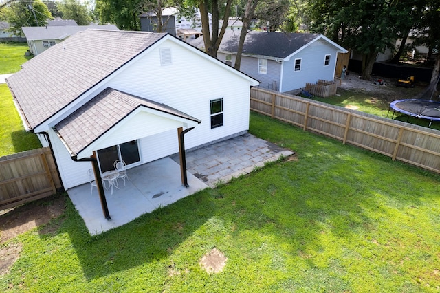 717 S Central St, Centralia, MO 65240 - back of house with a patio, a trampoline, and a fenced backyard