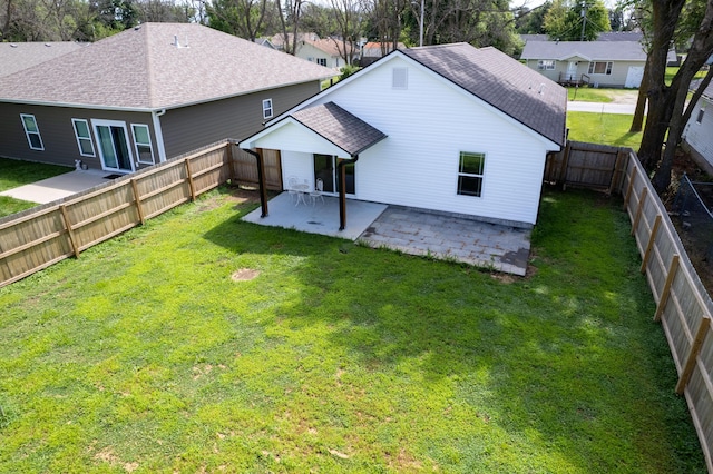 717 S Central St, Centralia, MO 65240 - rear view of property with a patio, a yard, and roof with shingles
