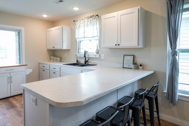 717 S Central St, Centralia, MO 65240 - kitchen with plenty of natural light, light countertops, a breakfast bar, wood finished floors, and recessed lighting