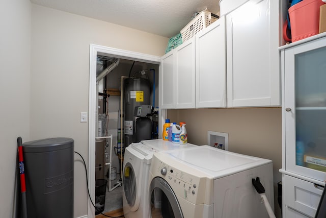 717 S Central St, Centralia, MO 65240 - washroom featuring independent washer and dryer, cabinet space, electric water heater, and a textured ceiling