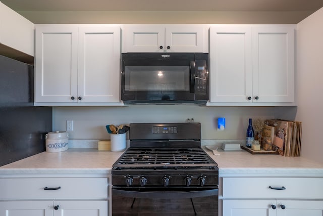 717 S Central St, Centralia, MO 65240 - kitchen with black appliances and white cabinets