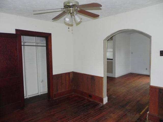 205 W Harrison St, Farber, MO 63345 - unfurnished room featuring arched walkways, hardwood / wood-style flooring, ceiling fan, and a wainscoted wall