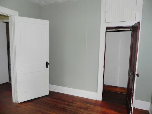 205 W Harrison St, Farber, MO 63345 - unfurnished bedroom featuring dark wood finished floors and baseboards