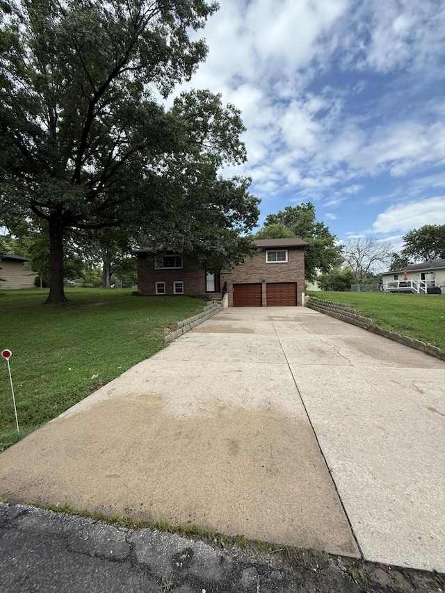 2220 N Lakeland Dr, Columbia, MO 65202 - view of front of house with driveway, a front lawn, an attached garage, and brick siding