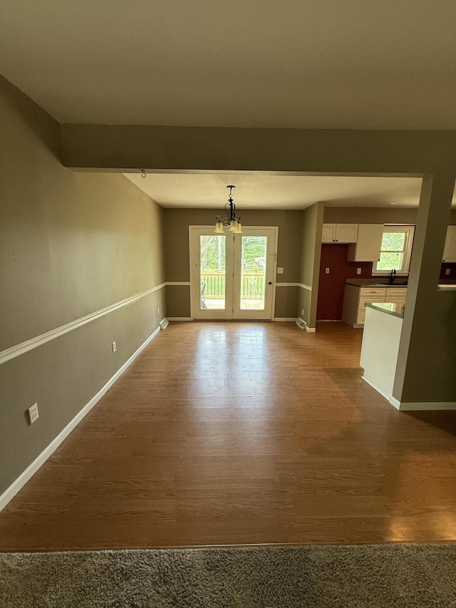2220 N Lakeland Dr, Columbia, MO 65202 - unfurnished living room featuring a chandelier and dark wood-style flooring