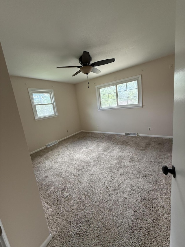 2220 N Lakeland Dr, Columbia, MO 65202 - spare room featuring healthy amount of natural light, ceiling fan, and carpet floors
