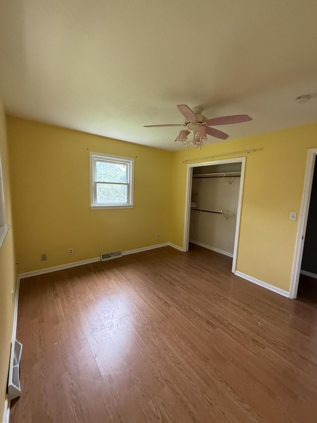 2220 N Lakeland Dr, Columbia, MO 65202 - unfurnished bedroom featuring wood finished floors, a closet, and ceiling fan