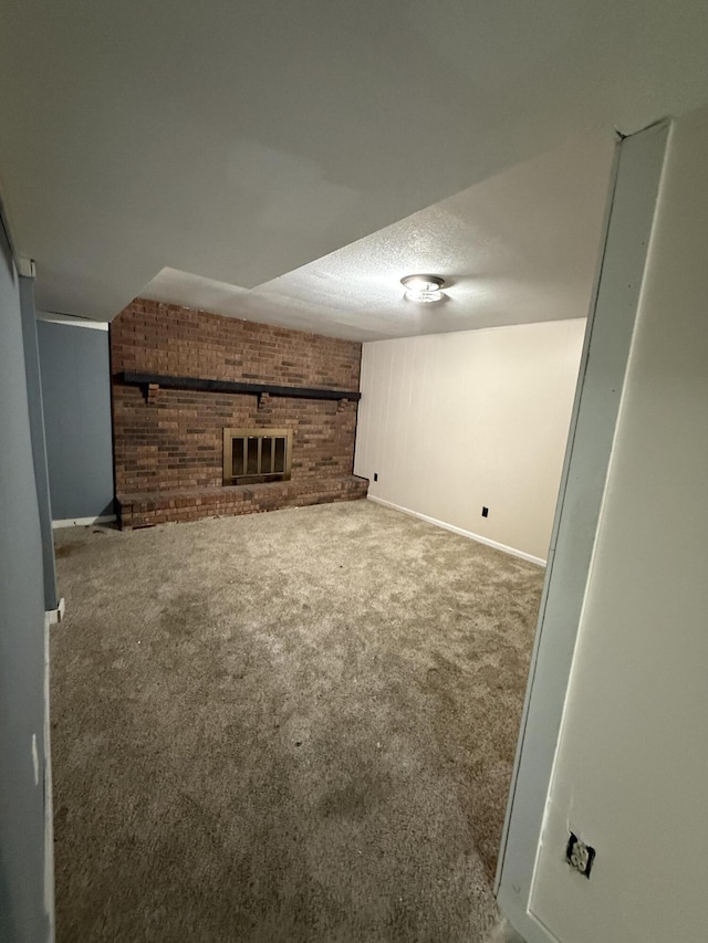 2220 N Lakeland Dr, Columbia, MO 65202 - unfurnished living room featuring carpet, brick wall, and a textured ceiling