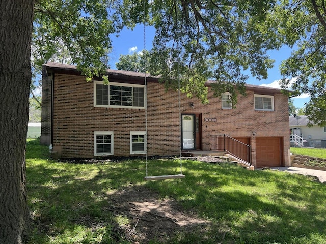 2220 N Lakeland Dr, Columbia, MO 65202 - bi-level home featuring a garage, brick siding, a front lawn, and concrete driveway