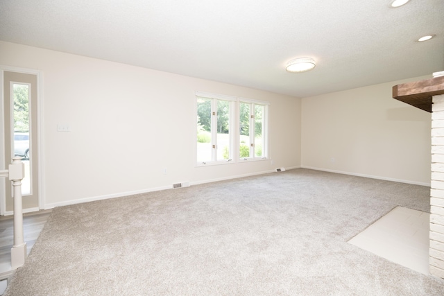 6303 S Old Village Rd, Columbia, MO 65203 - unfurnished living room with carpet floors and recessed lighting