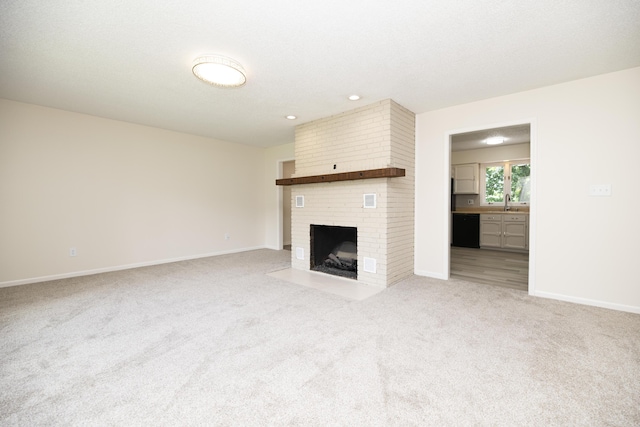 6303 S Old Village Rd, Columbia, MO 65203 - unfurnished living room with light carpet, a fireplace, and recessed lighting