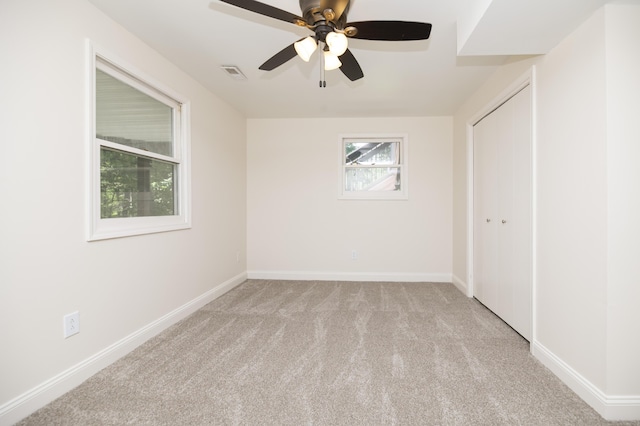 6303 S Old Village Rd, Columbia, MO 65203 - unfurnished bedroom with light carpet, a closet, and a ceiling fan