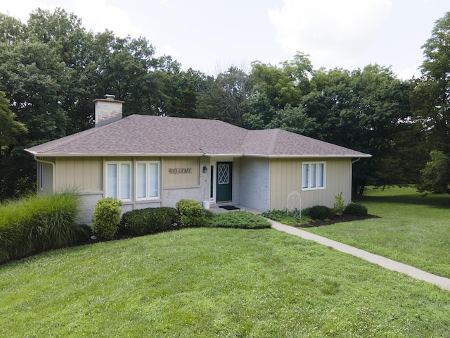 6303 S Old Village Rd, Columbia, MO 65203 - ranch-style house with a front yard, a chimney, and a shingled roof