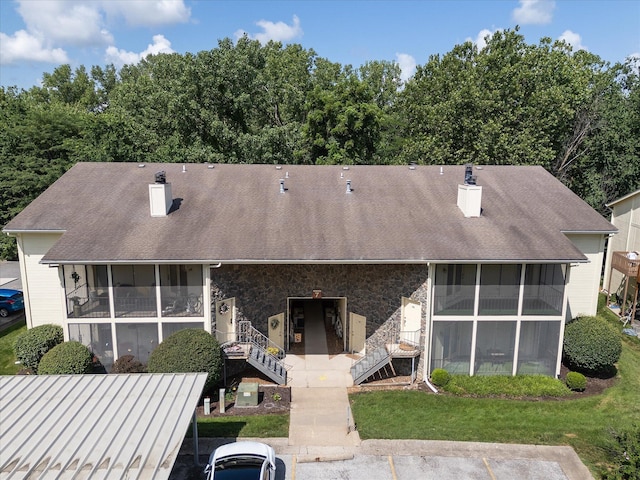 706 Park Deville Pl, Columbia, MO 65203 - view of front of house featuring a sunroom, a chimney, stone siding, and a shingled roof