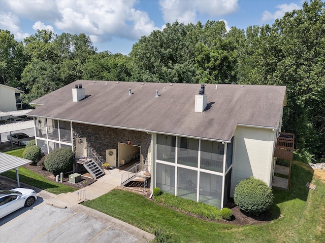 706 Park Deville Pl, Columbia, MO 65203 - back of house with a chimney, a sunroom, a yard, and a shingled roof