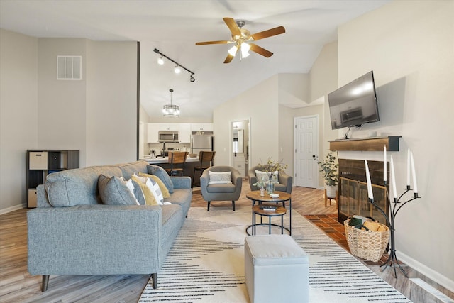 706 Park Deville Pl, Columbia, MO 65203 - living room featuring a ceiling fan, high vaulted ceiling, light wood-type flooring, and rail lighting