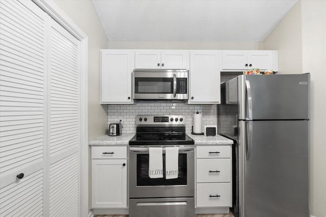 706 Park Deville Pl, Columbia, MO 65203 - kitchen with appliances with stainless steel finishes, white cabinetry, and backsplash