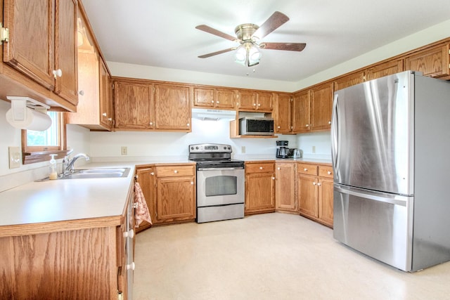 11657 Fletcher Ln, Holts Summit, MO 65043 - kitchen featuring stainless steel appliances, under cabinet range hood, light countertops, a ceiling fan, and brown cabinets