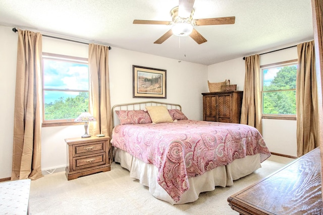 11657 Fletcher Ln, Holts Summit, MO 65043 - bedroom with light carpet, a textured ceiling, and ceiling fan