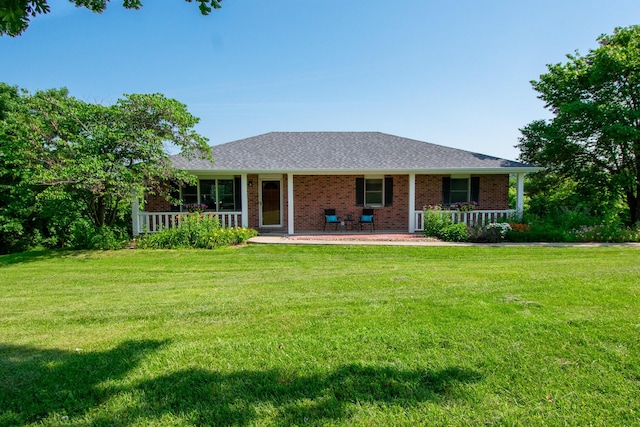 11657 Fletcher Ln, Holts Summit, MO 65043 - rear view of house featuring a porch, brick siding, a yard, and roof with shingles