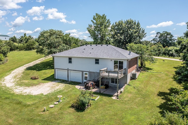 11657 Fletcher Ln, Holts Summit, MO 65043 - back of property featuring driveway, a wooden deck, an attached garage, a patio, and a lawn