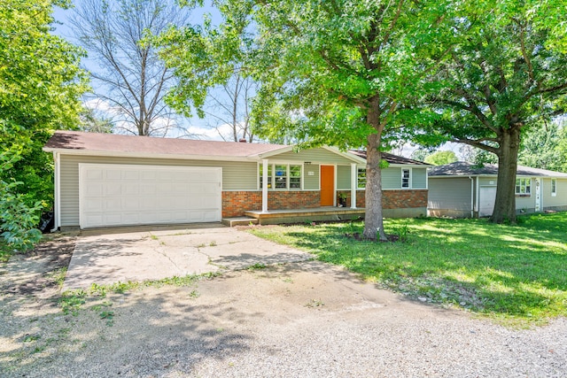 5704 N Teresa Dr, Columbia, MO 65202 - single story home with brick siding, driveway, a garage, and a front yard