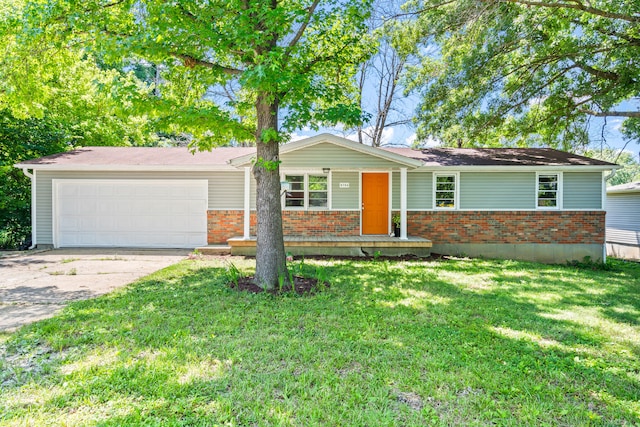 5704 N Teresa Dr, Columbia, MO 65202 - single story home with an attached garage, driveway, brick siding, a front yard, and covered porch