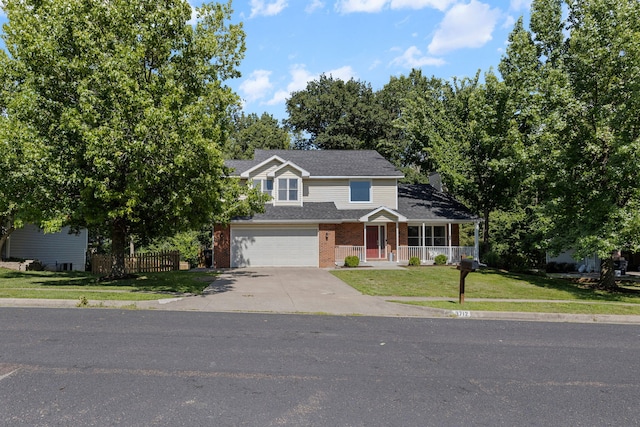 3712 Godfrey Dr, Columbia, MO 65203 - traditional-style home featuring covered porch, concrete driveway, brick siding, a garage, and a shingled roof