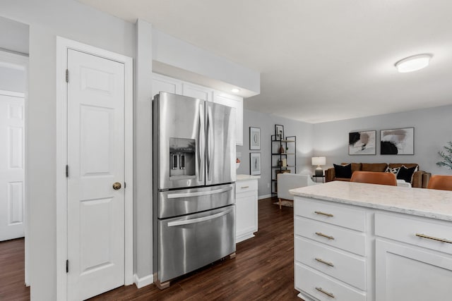 3712 Godfrey Dr, Columbia, MO 65203 - kitchen featuring stainless steel fridge, dark wood finished floors, white cabinetry, light stone countertops, and open floor plan