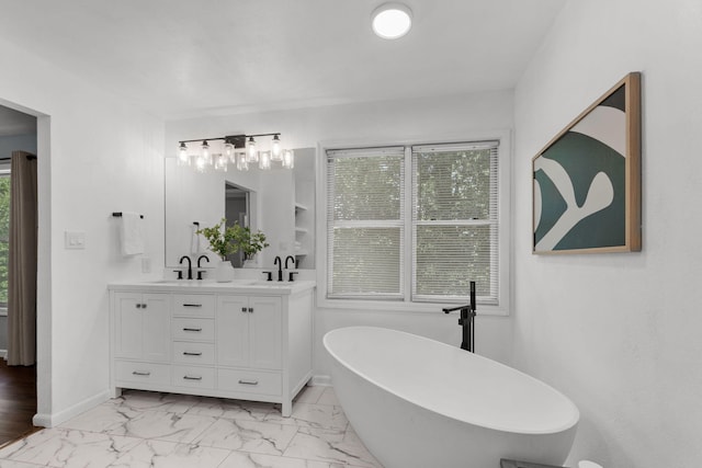 3712 Godfrey Dr, Columbia, MO 65203 - bathroom featuring double vanity, a soaking tub, and marble look tiles