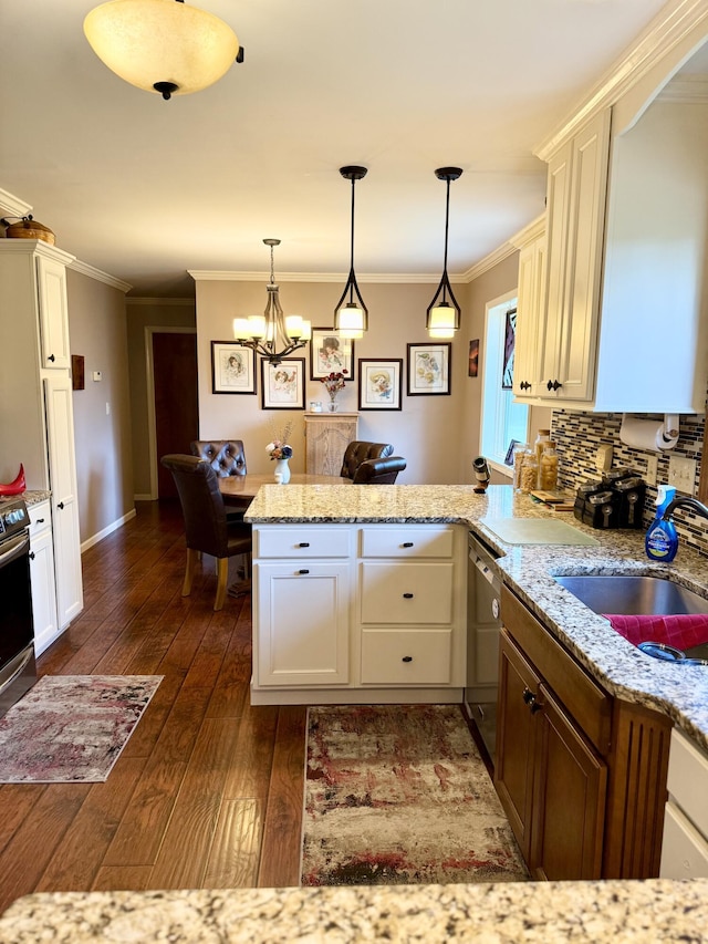 1620 S Berkley Dr, Columbia, MO 65201 - kitchen with a peninsula, dark wood-style flooring, a chandelier, ornamental molding, and hanging light fixtures