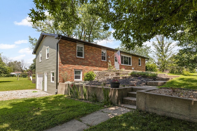 661 N W Park Ln, Columbia, MO 65201 - view of front facade featuring an attached garage, brick siding, a front yard, and driveway