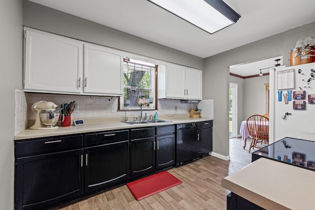 661 N W Park Ln, Columbia, MO 65201 - kitchen with dishwasher, freestanding refrigerator, dark cabinetry, white cabinets, and light wood-style flooring
