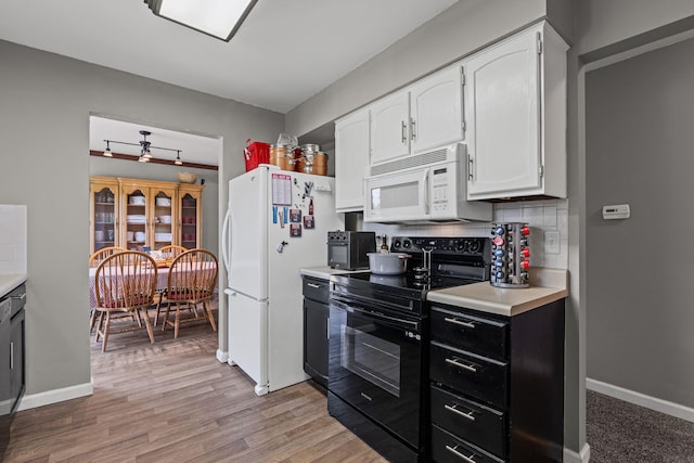661 N W Park Ln, Columbia, MO 65201 - kitchen featuring white appliances, white cabinetry, light countertops, and light wood-style floors