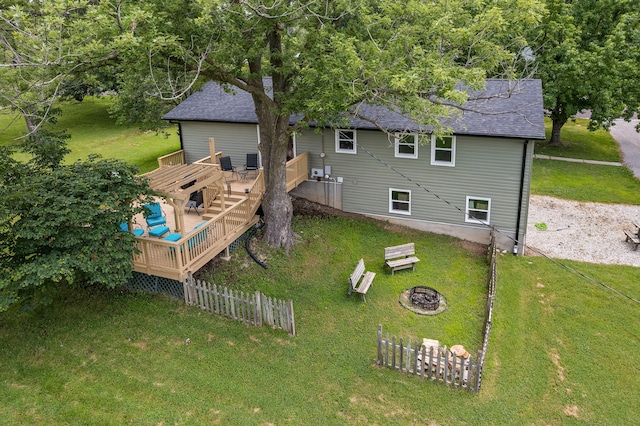 661 N W Park Ln, Columbia, MO 65201 - rear view of property with a wooden deck, an outdoor fire pit, a yard, and a shingled roof