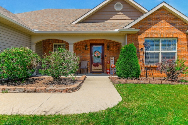 5805 Vero Way, Columbia, MO 65201 - entrance to property featuring brick siding, covered porch, a lawn, and a shingled roof