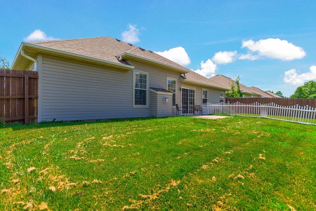 5805 Vero Way, Columbia, MO 65201 - rear view of property featuring a fenced backyard, roof with shingles, and a patio
