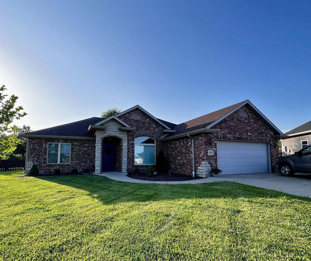 1601 Andretti Cir, Columbia, MO 65201 - single story home featuring brick siding, a front yard, an attached garage, and a shingled roof