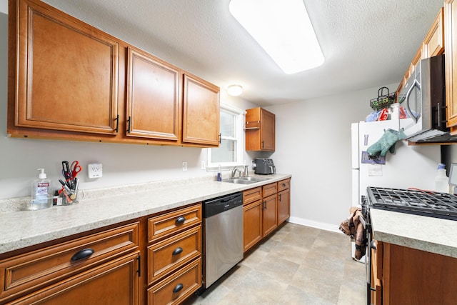 1601 Parklawn Ct, Columbia, MO 65202 - kitchen featuring stainless steel appliances, light countertops, brown cabinets, and a textured ceiling