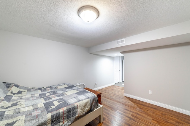 1601 Parklawn Ct, Columbia, MO 65202 - bedroom featuring wood finished floors and a textured ceiling