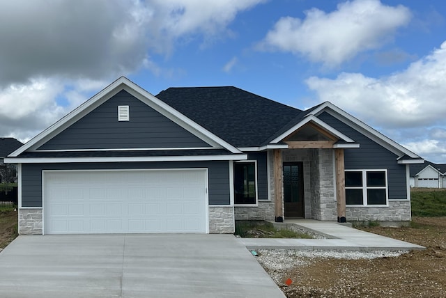 913 Spyglass Ct, Columbia, MO 65201 - view of front of house featuring stone siding, driveway, an attached garage, and a shingled roof