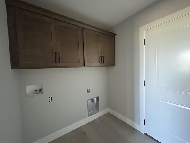 913 Spyglass Ct, Columbia, MO 65201 - laundry area featuring hookup for a washing machine, cabinet space, light wood-style floors, and electric dryer hookup