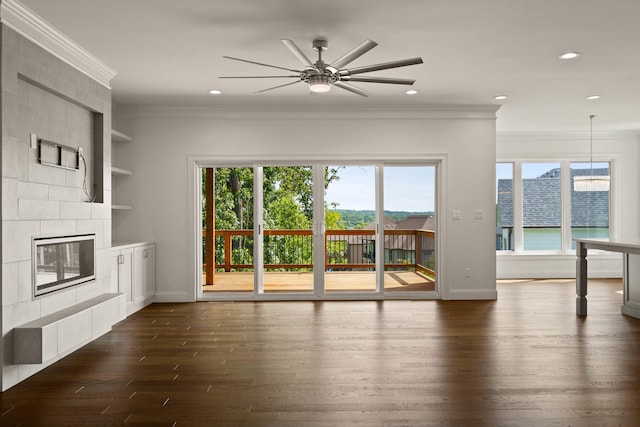 3001 Rivington Dr, Columbia, MO 65203 - unfurnished living room featuring dark wood-style floors, ceiling fan, crown molding, recessed lighting, and a tiled fireplace