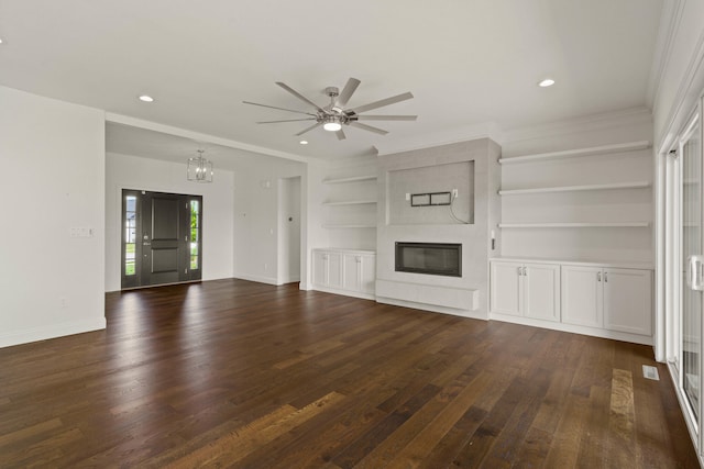 3001 Rivington Dr, Columbia, MO 65203 - unfurnished living room featuring dark wood finished floors, a large fireplace, ornamental molding, a chandelier, and ceiling fan