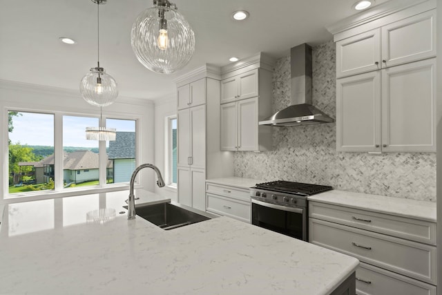 3001 Rivington Dr, Columbia, MO 65203 - kitchen with wall chimney exhaust hood, stainless steel gas range oven, decorative backsplash, recessed lighting, and hanging light fixtures